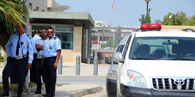 Sept. 12, 2012: Police officers guard the United States embassy in Tunis, as ultraconservative Muslims demonstrate outside the embassy to demand the closure of the embassy and the departure of the ambassador.