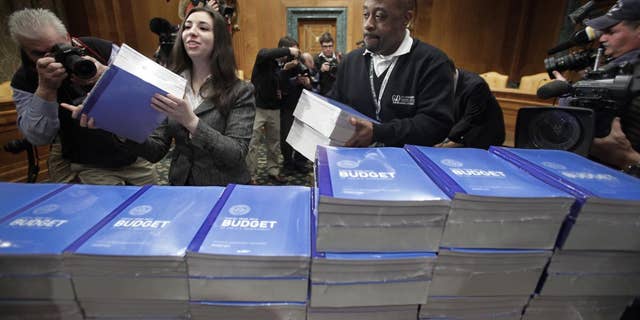 Copies of President Obama's 2012 budget are delivered to the Senate Budget Committee, Monday, Feb. 14, 2011, on Capitol Hill in Washington. (AP Photo/J. Scott Applewhite)