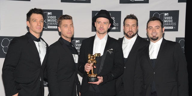 August 25, 2013: Justin Timberlake, center, winner of the video vanguard award poses backstage with, from left, JC Chasez, Lance Bass, Joey Fatone and Chris Kirkpatrick of 'N Sync at the MTV Video Music Awards at the Barclays Center in the Brooklyn borough of New York. (Photo by Evan Agostini/Invision/AP)