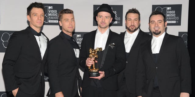 August 25, 2013: Justin Timberlake, center, winner of the video vanguard award poses backstage with, from left, JC Chasez, Lance Bass, Joey Fatone and Chris Kirkpatrick of 'N Sync at the MTV Video Music Awards at the Barclays Center in the Brooklyn borough of New York. (Photo by Evan Agostini/Invision/AP)