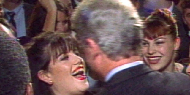 President Clinton greets Monica Lewinsky (L) at a Washington fundraising event in October 1996.