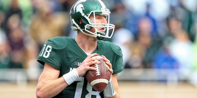 Oct 24, 2015; East Lansing, MI, USA; Michigan State Spartans quarterback Connor Cook (18) attempts to throw the ball against the Indiana Hoosiers during the 1st half of a game at Spartan Stadium. Mandatory Credit: Mike Carter-USA TODAY Sports