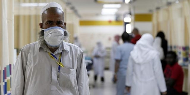 A Muslim pilgrim wears a protective mask in the emergency department at Al-Noor Specialist Hospital in Mecca September 30, 2014. REUTERS/ Muhammad hamed