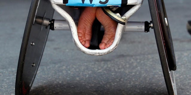 The feet of an athlete are tucked into his wheelchair at the 116th Boston Marathon in Boston, Massachusetts April 16, 2012. REUTERS/Brian Snyder