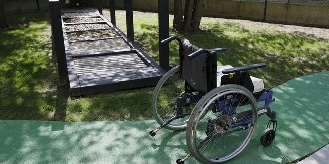 A wheelchair is pictured next to a walking frame during a media presentation in the 300-square-metre therapeutic garden of the Acute Neurological Rehabilitation Unit at Lausanne University Hospital (CHUV) in Lausanne, Switzerland, August 25, 2015. REUTERS/Denis Balibouse