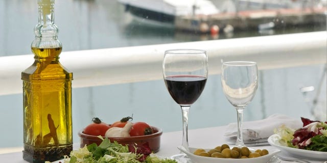 Food is seen on a table at a restaurant at the port of El Masnou, near Barcelona May 16, 2008. REUTERS/Albert Gea