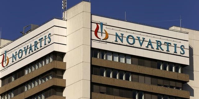 The logo of Swiss pharmaceutical company Novartis is seen on its headquarters building in Basel, Switzerland October 27, 2015. Novartis agreed in principle to pay $390 million to settle U.S. allegations that it used kickbacks to speciality pharmacies to push sales of some drugs, the Swiss company said on Tuesday, hitting third-quarter earnings. REUTERS/Arnd Wiegmann