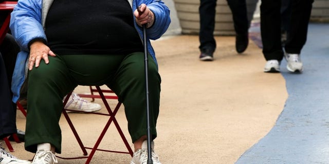 An overweight woman sits on a chair in Times Square in New York, May 8, 2012. REUTERS/Lucas Jackson
