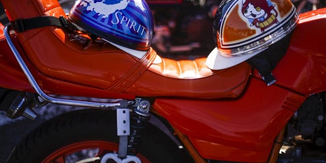 Helmets rest on the seat of a Bousouzoku style motorbike. REUTERS/Thomas Peter