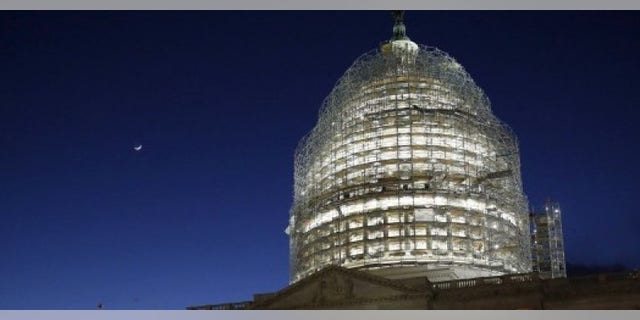 The sun sets behind the U.S. Capitol dome in the hours before President Barack Obama delivers the State of the Union address to a joint session of Congress in Washington January 12, 2016. REUTERS/Jonathan Ernst