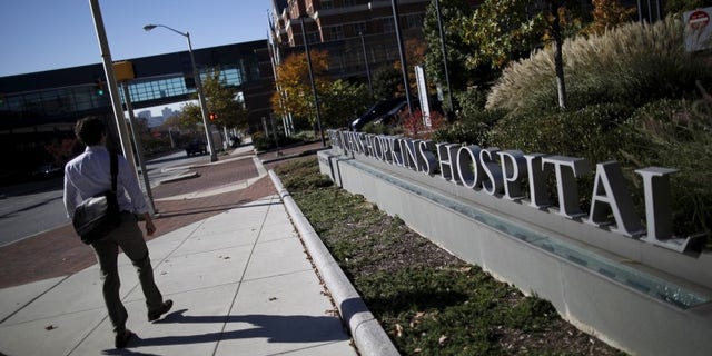 A man walks by the John Hopkins Hospital in Baltimore, Maryland November 4, 2015. REUTERS/Carlos Barria