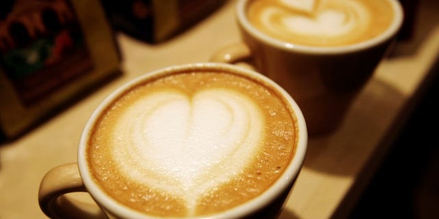 Cups of cappuccino sit on a table during the World Coffee Conference in Guatemala City