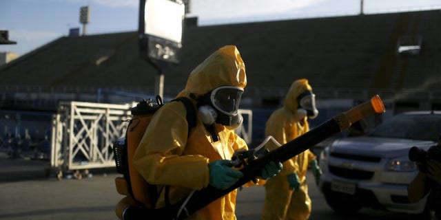 Municipal workers spray insecticide at Sambodrome in Rio de Janeiro