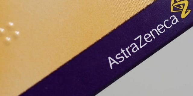 The logo of AstraZeneca is seen on a medication package in a pharmacy in London