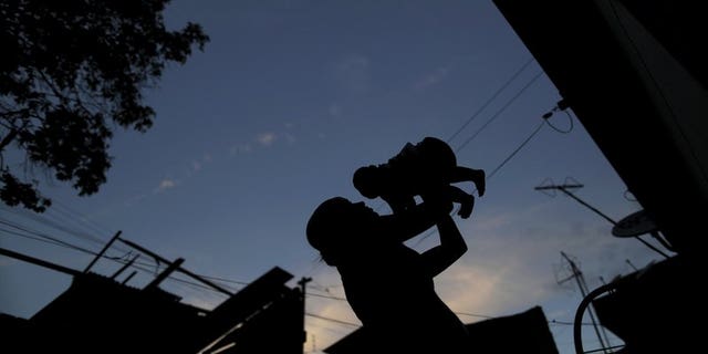 Gleyse Kelly da Silva holds her daughter Maria Giovanna, who has microcephaly, near their house in Recife