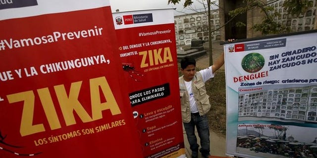 A health worker gives information during a preventive campaign against the Zika virus and other mosquito-borne diseases, at the cemetery of Presbitero Maestro in Lima