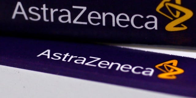 The logo of AstraZeneca is seen on medication packages in a pharmacy in London