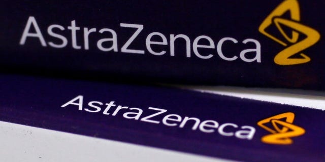 The logo of AstraZeneca is seen on medication packages in a pharmacy in London