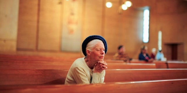 People pray after learning of the newly elected Pope Francis at the Cathedral of Our Lady of the Angels in Los Angeles, California