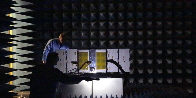 As part of a series of environmental tests for NASA’s CYGNSS constellation, one of the eight microsatellites is placed in a radio frequency (RF) anechoic chamber.