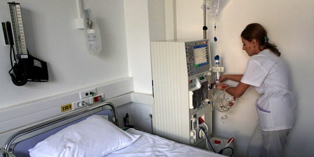 Nurse Georgiana Stefan prepares a dialysis machine for a diabetes patient at Nicolae Paulescu National Institute for Diabetes, Nutrition and Metabolic Diseases in Bucharest