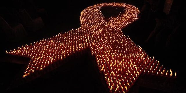 About 2880 candles are seen lit during a World AIDS Day event in Jakarta