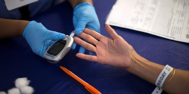 A person receives a test for diabetes during Care Harbor LA free medical clinic in Los Angeles