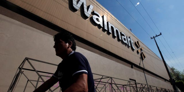 A person walks outside a Wal-Mart store in Mexico City