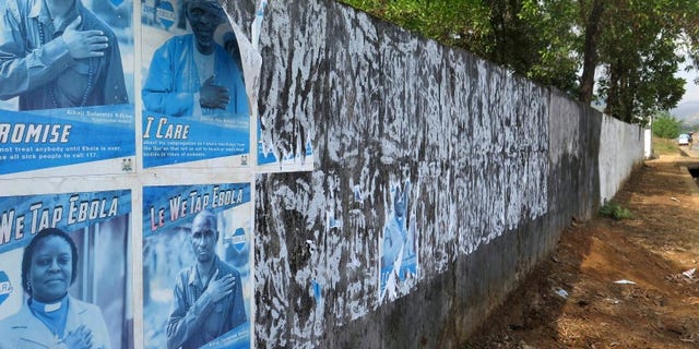 Ebola awareness posters are seen peeling off the wall in Freetown