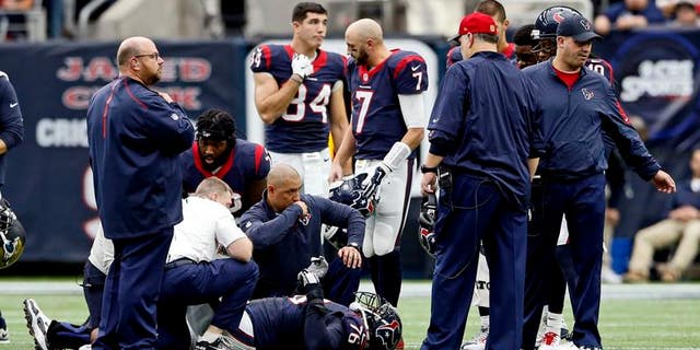 Houston Texans tackle Duane Brown is examined by team medical staff after being injured during the first half against the Jacksonville Jaguars at NRG Stadium in Houston, Texas
