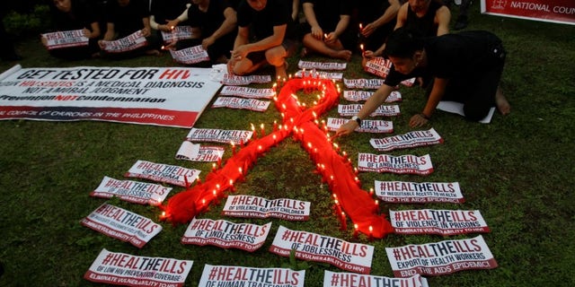 People light candles to mark World AIDS day in Quezon city, Metro Manila, Philippines