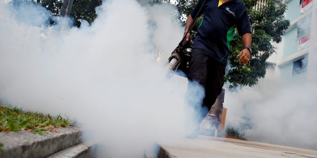 File picture of a worker fogging the common area of a public housing estate at a new Zika cluster in Singapore
