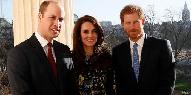 Britain's Prince William, Kate Duchess of Cambridge and Prince Harry pose for p hotograph at the Institute of Contemporary Arts in central London