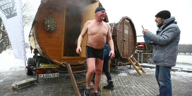 Man leaves sauna during Belarusian winter swimming championship in Minsk