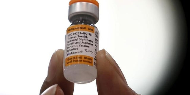 A nurse displays a tetanus, diphtheria and pertussis whooping cough vaccine at a free medical and dental health clinic in Los Angeles
