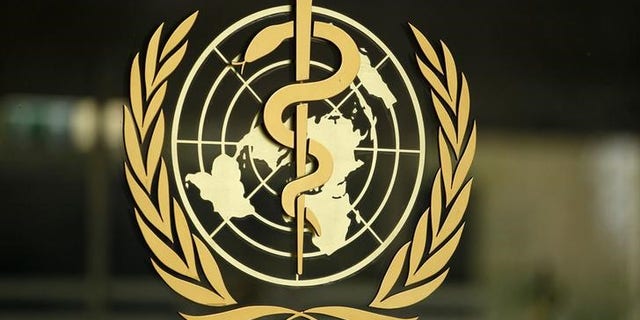 The WHO logo is pictured at the entrance of its headquarters in Geneva