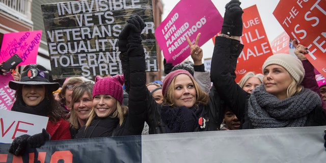 Actresses Chelsea Handler and Charlize Theron, right, participate in the "Women's March On Main" during the 2017 Sundance Film Festival on Saturday, Jan. 21, 2017, in Park City, Utah. (Photo by Arthur Mola/Invision/AP)