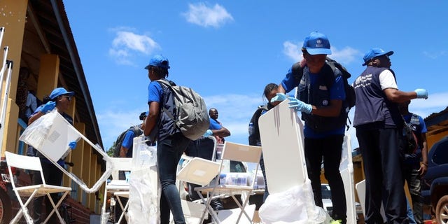 World Health Organization workers prepare a centre for vaccination in the port city of Mbandaka