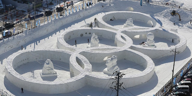 Visitors tour near the snow sculpture in the shape of the Olympic rings at a snow festival in Pyeongchang, South Korea. Pyeongchang is the host city for the 2018 Olympic and Paralympic Winter Games.