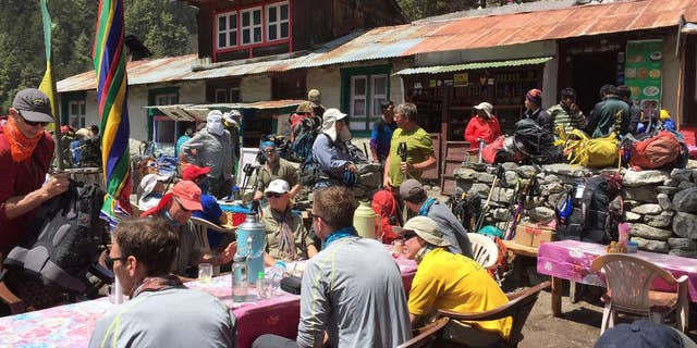 This April 6, 2016 photo shows trekkers at a rest stop north of the village of Namche Bazaar, Nepal. A trek to Everest Base Camp along mountain paths that hug deep gorges offers renewal and a test of mental and physical limits. (AP Photo/Karin Laub)