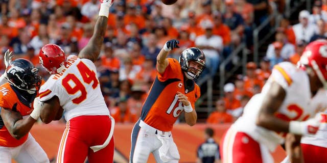 Denver Broncos quarterback Peyton Manning (18) throws against the Kansas City Chiefs during the second half of an NFL football game, Sunday, Sept. 14, 2014, in Denver. (AP Photo/Joe Mahoney)