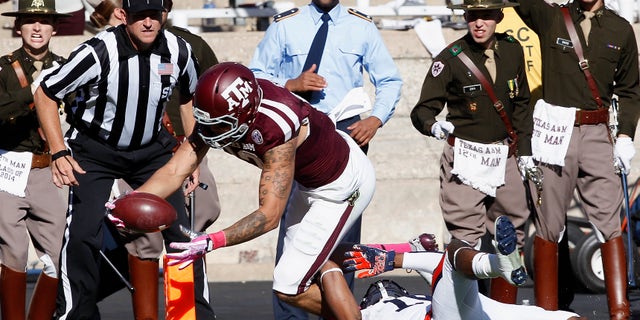 Texas A&M wide receiver Mike Evans (13) dives into the end zone for a touchdown in the quarter second quarter as Auburn defensive back Ryan White (19) cannot make the tackle during an NCAA college football game Saturday, Oct. 19, 2013, in College Station, Texas. (AP Photo/Bob Levey)