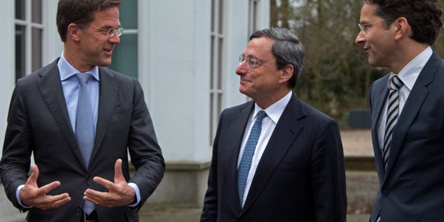 Dutch Prime Minister Mark Rutte, European Central Bank chief Mario Draghi, and Eurogroup President and Dutch Finance minister Jeroen Dijsselbloem, from left to right, pose for photographers prior to a meeting in The Hague, Netherlands, Monday April 15, 2013. Draghi will address Amsterdam students later in the day on the role of monetary policy in addressing the European debt crisis. (AP Photo/Peter Dejong)