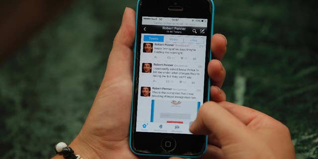 Twitter page of Canadian man, Robert Penner is seen on the screen of a mobile phone in Kathmandu, Nepal, Tuesday, May 3, 2016. Nepalese officials say they have ordered Penner to leave the country within two days for posting messages on social media that could disturb social harmony. (AP Photo/Niranjan Shrestha)