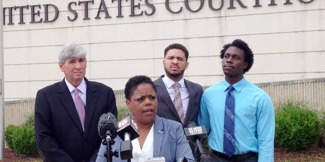 Jennifer Riley-Collins, executive director of the American Civil Liberties Union of Mississippi, center, speaks Monday, May 9, 2016, in Jackson, Miss., about a lawsuit the group filed against the state over House Bill 1523, which will allow workers to cite their own religious objections to same-sex marriage and deny services to citizens. Behind Riley-Collins are attorney Oliver Diaz, left, and plaintiffs in the lawsuit, Nykolas Alford and Stephen Thomas. Alford and Thomas, of Meridian, Miss., are engaged. The lawsuit asks a federal judge to declare that House Bill 1523 violates the equal-protection guarantee of the 14th Amendment and to block the state from enforcing the measure, which is set to become law July 1. (AP Photo/Emily Wagster Pettus)