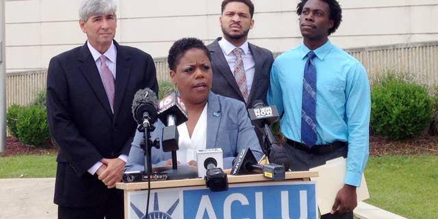 Jennifer Riley-Collins, executive director of the American Civil Liberties Union of Mississippi, center, speaks Monday, May 9, 2016, in Jackson, Miss., about a lawsuit the group filed against the state over House Bill 1523, which will allow workers to cite their own religious objections to same-sex marriage and deny services to citizens. Behind Riley-Collins are attorney Oliver Diaz, left, and plaintiffs in the lawsuit, Nykolas Alford and Stephen Thomas. Alford and Thomas, of Meridian, Miss., are engaged. The lawsuit asks a federal judge to declare that House Bill 1523 violates the equal-protection guarantee of the 14th Amendment and to block the state from enforcing the measure, which is set to become law July 1. (AP Photo/Emily Wagster Pettus)
