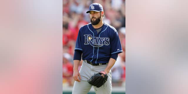 Tampa Bay Rays relief pitcher Josh Lueke turns toward the mound after giving up a pinch-hit grand slam to Cincinnati Reds' Chris Heisey in the eighth inning of a baseball game, Sunday, April 13, 2014, in Cincinnati. Cincinnati won 12-4. (AP Photo/Al Behrman)