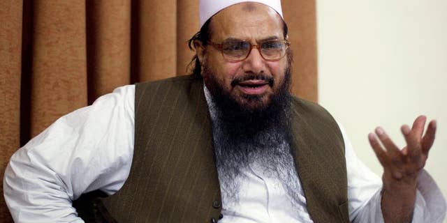 FILE - In this April 3, 2012, file photo, Hafiz Mohammed Saeed, chief of Jamaat-ud-Dawwa and founder of Lashkar-e-Taiba talks with the Associated Press in Islamabad, Pakistan. A lawyer for the suspected Pakistani militant wanted by the U.S. said Thursday a court has banned an upcoming Bollywood movie that imagines his client being assassinated. Hafiz Mohammed Saeed, who has a $10 million bounty on his head over his alleged involvement in the 2008 Mumbai attacks, had petitioned the Lahore High Court to ban the film "Phantom," saying it posed a threat to his life and was Indian propaganda meant to hurt Pakistan's image. (AP Photo/B.K. Bangash, File)