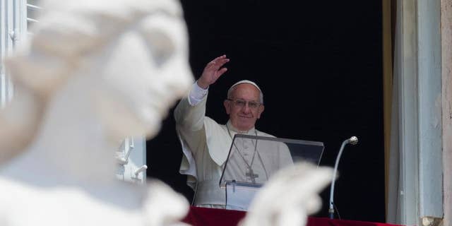 Pope Francis delivers his blessing during the Angelus noon prayer he celebrated from the window of his studio overlooking St. Peter's Square, at the Vatican, Sunday, July 10, 2016. (AP Photo/Andrew Medichini)