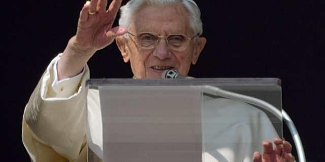 FILE - In this Feb. 17, 2013 file photo, Pope Benedict XVI acknowledges a cheering crowd of faithful and pilgrims during his second-last Angelus prayer from the window of his apartments at the Vatican. As the first pontiff in six centuries to step down, Benedict has carved a new path for his successors who decide they cannot rule for life. But scholars say the repercussions could reach beyond just changing how pontiffs leave to ultimately shape perceptions about the authority and significance of the pontificate. (AP Photo/Domenico Stinellis)